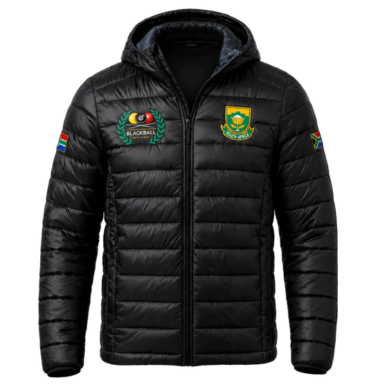 A black hooded puffer jacket with quilted horizontal stitching, featuring a South Africa national team crest on the left chest, a team emblem on the right chest, and colorful sleeve patches, displayed against a dark background.